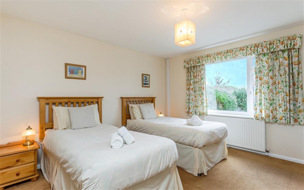Bedroom 2 with twin beds overlooks the garden at Little Haven in Colyton