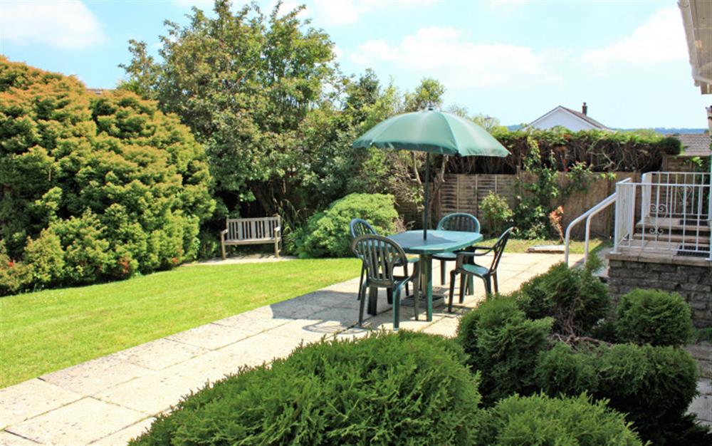 The enclosed garden has a patio and lawned area at Little Haven in Colyton