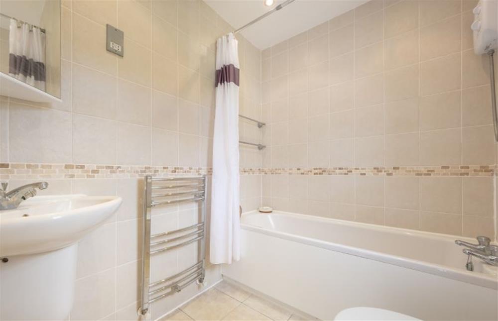 Bathroom with bath with shower overhead at Little Hayman, Thornham near Hunstanton