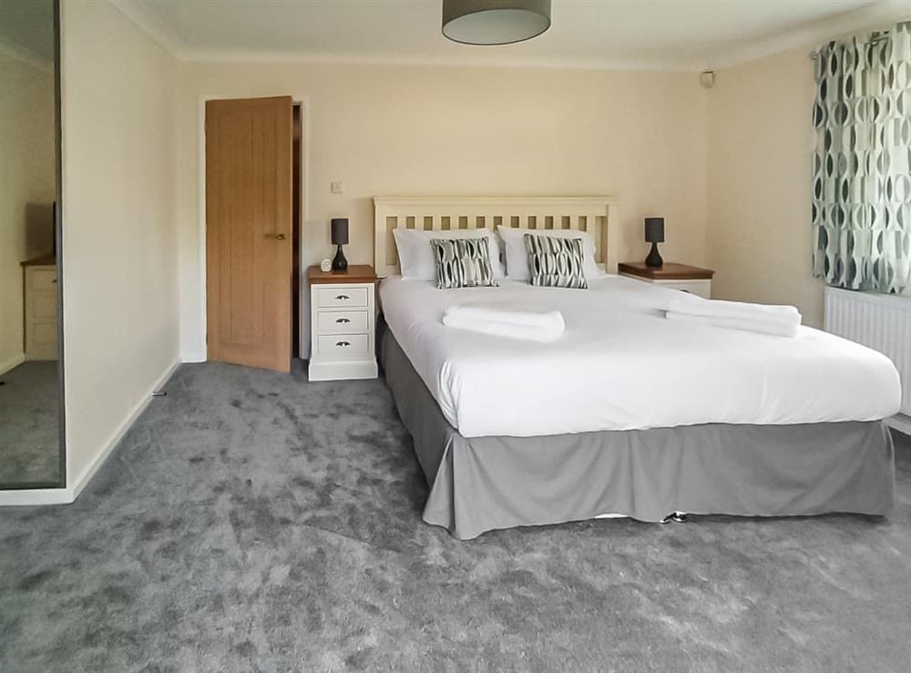 The master bedroom with direct access to toilet/shower facilities at Little Hill Farm Villa in Ringwood, Dorset