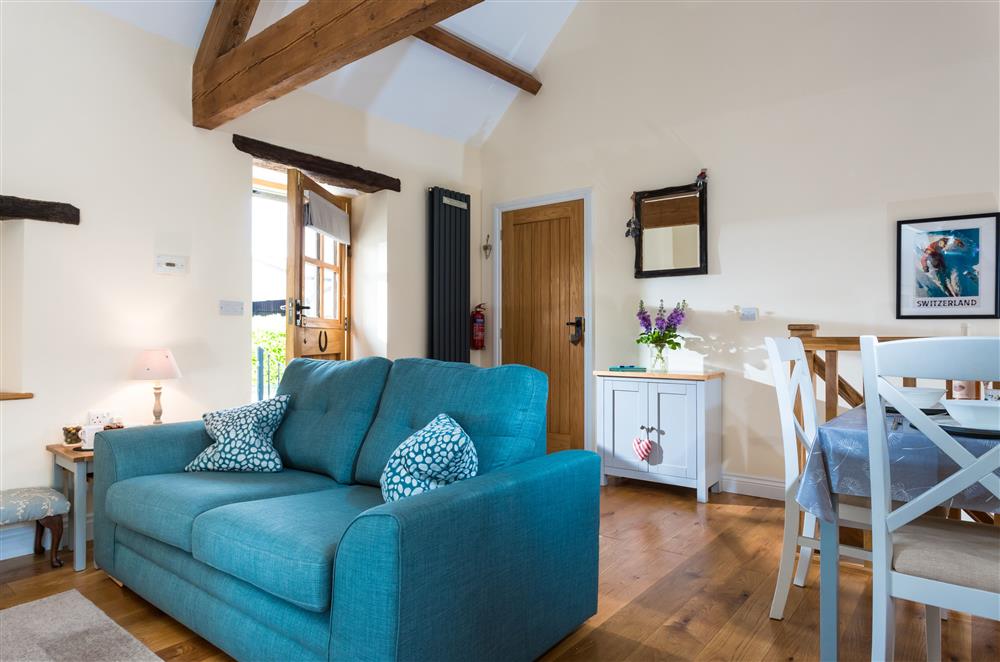 The open-plan living space with a door leading into Rivington Barn