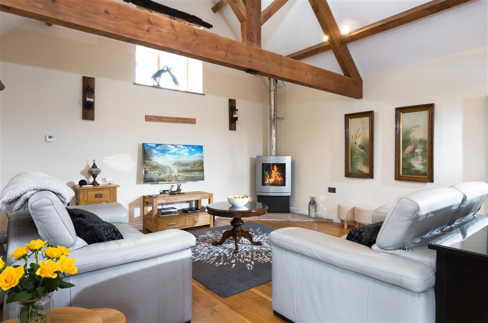 The sitting area with exposed beams and a log effect gas fire