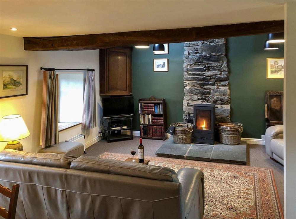Warm and welcoming living room with wood burner at Little Knott in Blawith, near Coniston, Cumbria