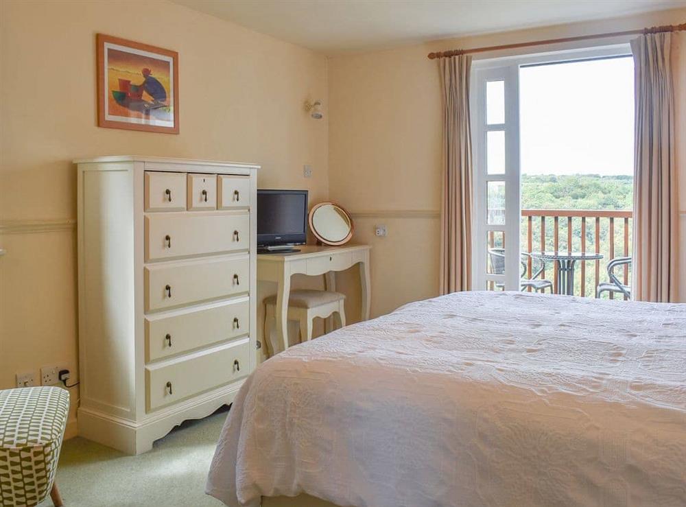 Wonderful views through the French doors in the bedroom at Little Larnick in Looe, Cornwall