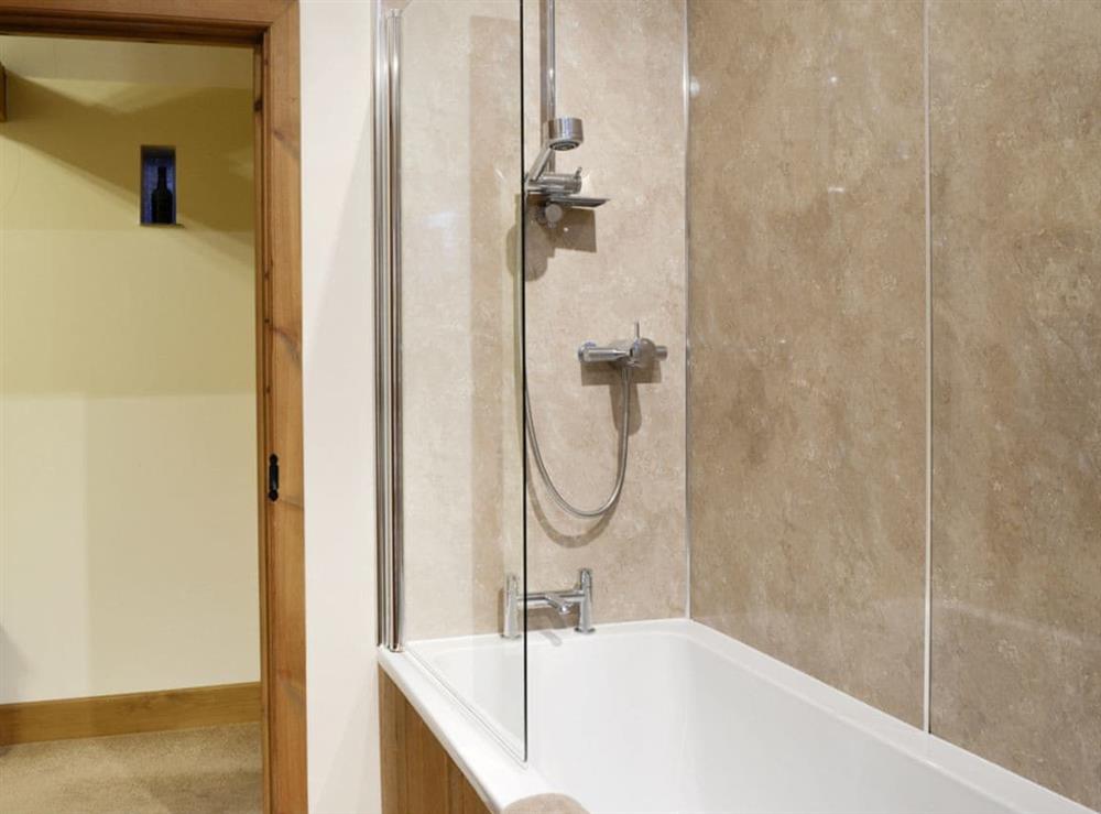 Family bathroom with shower over bath at Little Meadow in Dearham, near Maryport, Cumbria