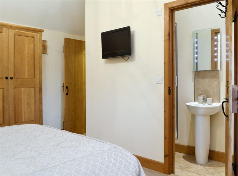 Wall mounted TV and en-suite shower room at Little Meadow in Dearham, near Maryport, Cumbria