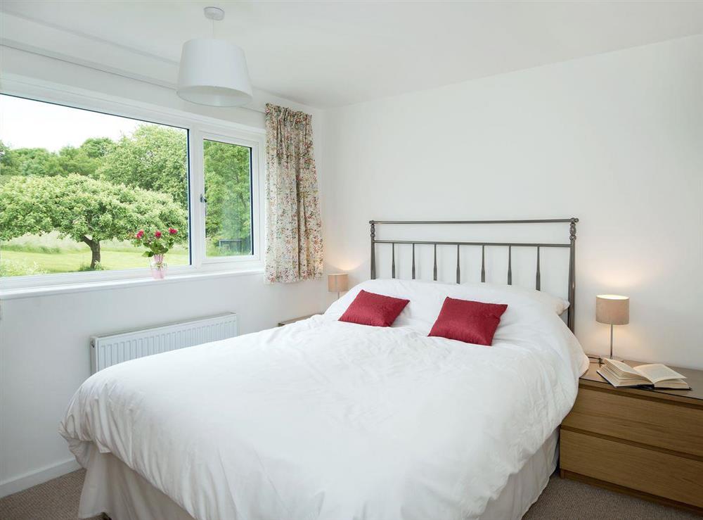Comfortable double bedroom with kingsize bed and en-suite with shower cubicle at Little Orchard in High Littleton, near Bath, Avon
