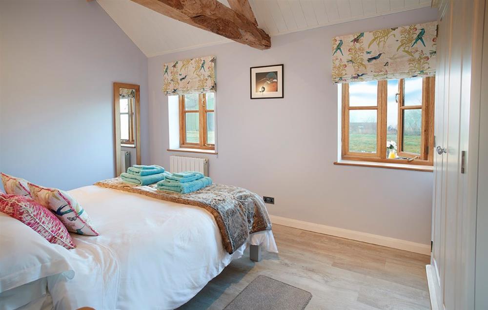 Bedroom with 5’ king-size bed at Little Owls Barn, Preston Wynne