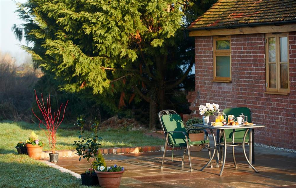 The patio and outdoor seating area is perfect for barbeques at Little Owls Barn, Preston Wynne