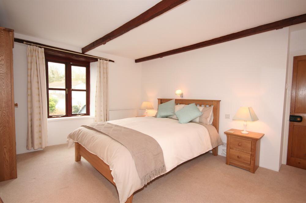 Master bedroom with King-size oak bed at Little Perriotts in Kellaton, Nr Kingsbridge