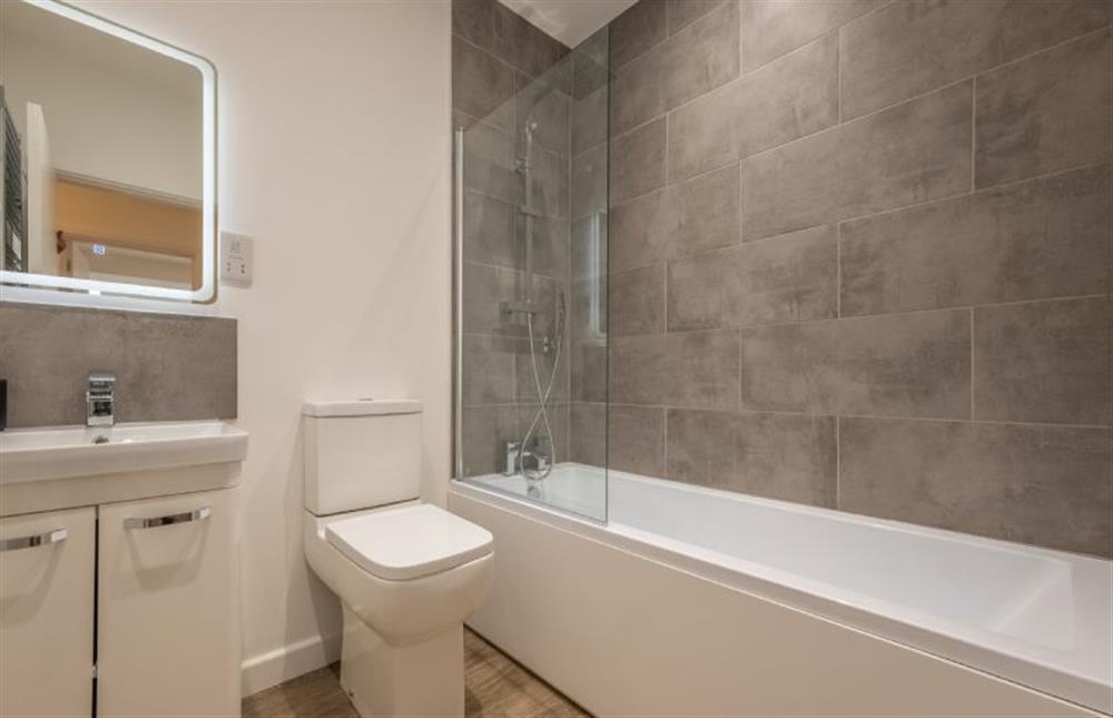 Family bathroom with a bath and shower over, wash basin and WC at Little Soames, Holt