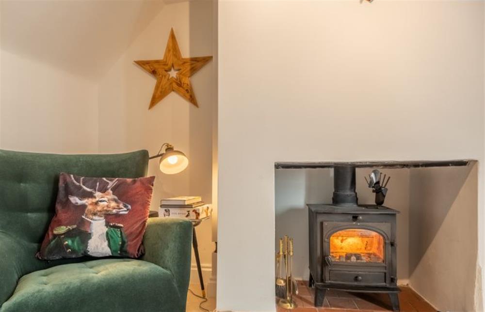 A cosy spot beside the fire at Little Star Cottage, East Rudham near Kings Lynn