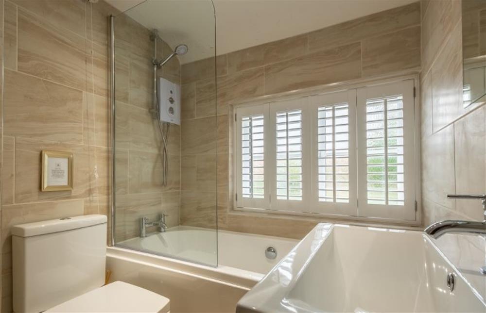 Bathroom with bath and overhead shower at Little Star Cottage, East Rudham near Kings Lynn