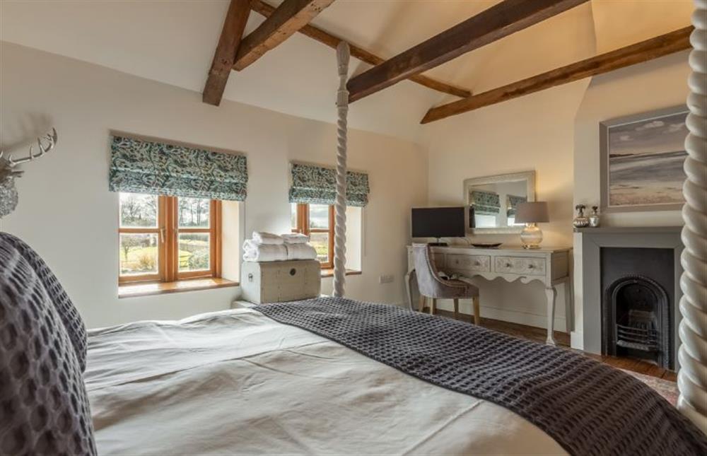First floor:  Master bedroom with feature fireplace at Little Star, Ringstead near Hunstanton