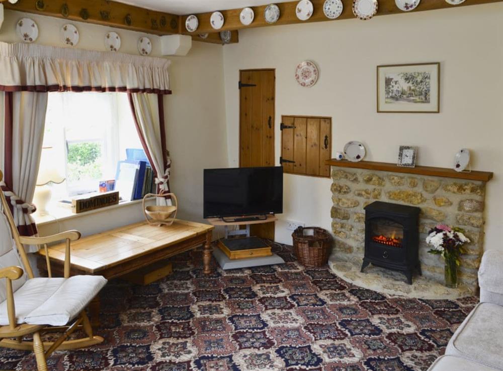 Cosy living and dining room at Little Thatch in Netherbury, near Beaminster, Dorset