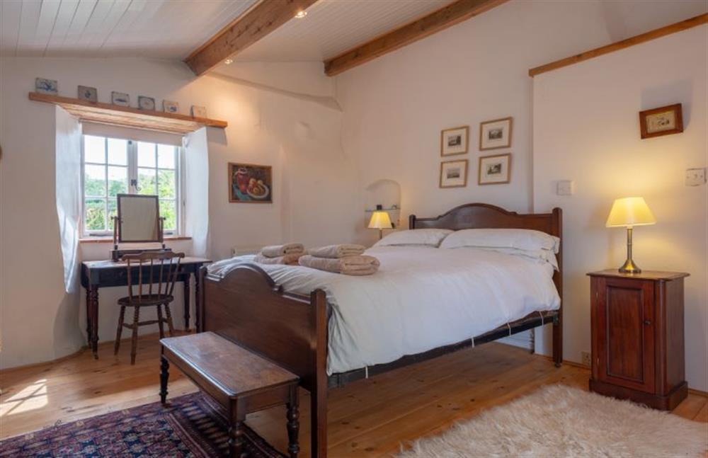 The Annexe has antique furniture and a large bed at Little Wells, North Creake near Fakenham