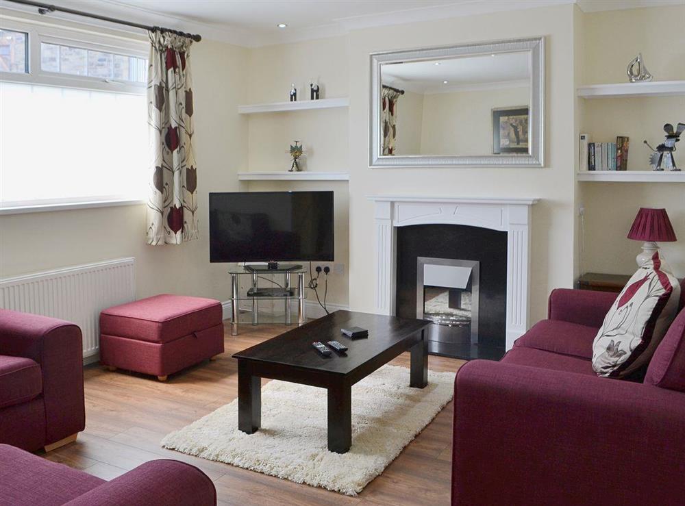 Comfortable living room with wooden floor at Little Woodlands Amble in Amble, Northumberland