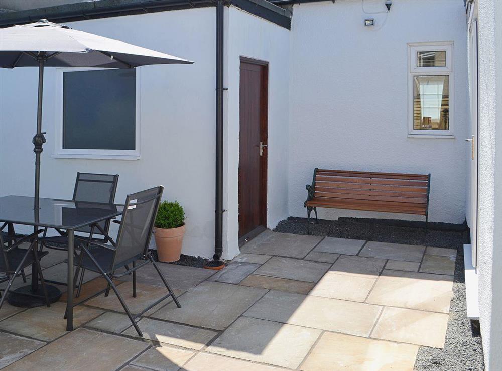 The courtyard garden offers outdoor eating at Little Woodlands Amble in Amble, Northumberland