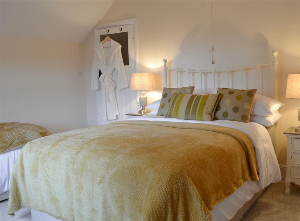 Double bedroom with an additional single bed at Littlewood in Newquay, Cornwall