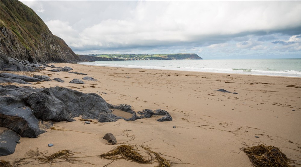 The secluded sandy beach at Llanborth Farmhouse in Llandysul, Mid Wales