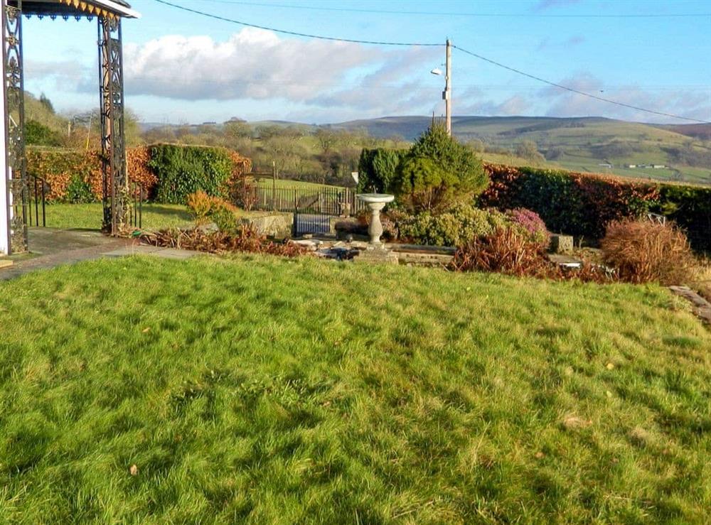 Large lawned garden at Llansantffraed House in Hundred House, near Llandrindod Wells, Powys
