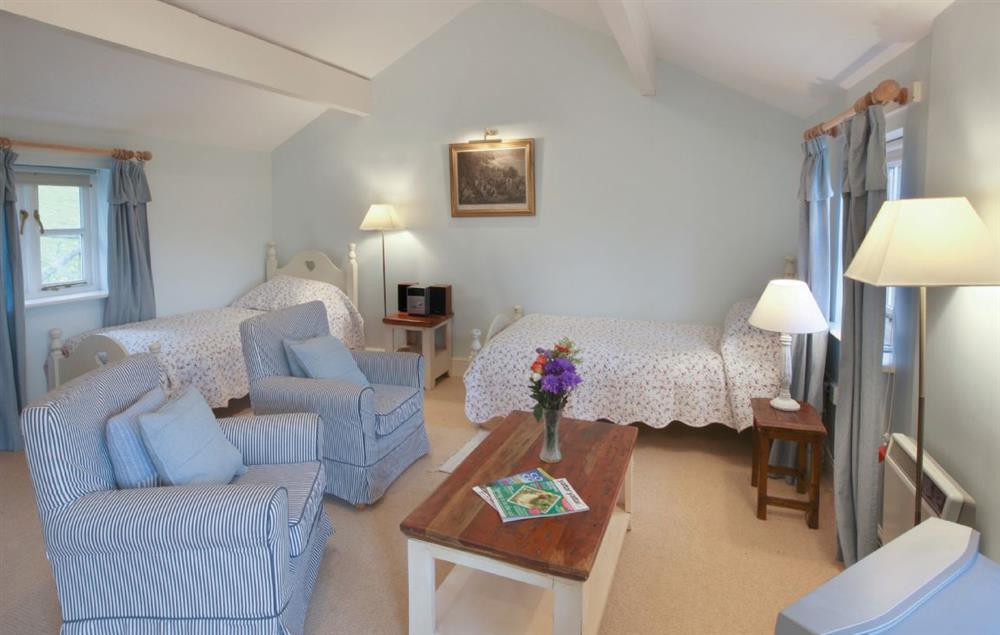Living area with twin 3’ single beds and seating area at Lletty and Annexe, Bodnant Estate, Colwyn Bay