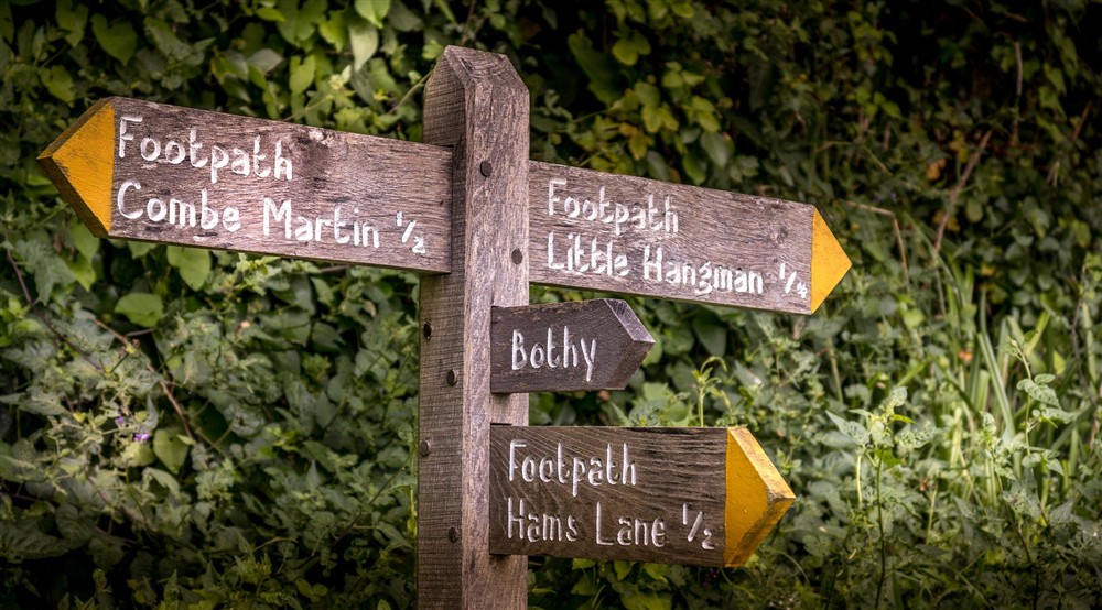 Signs for West Challacombe Bothy and footpaths to Combe Martin village (half a mile away) and Little Hangman Hill (a quarter of a mile away), Devon at Llyndy Bothy in Beddgelert, Gwynedd