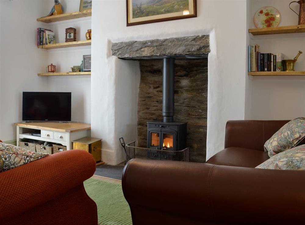 Comfortable living room with open fireplace at Llys Deulyn in Trefriw, near Betws-y-Coed, Gwynedd