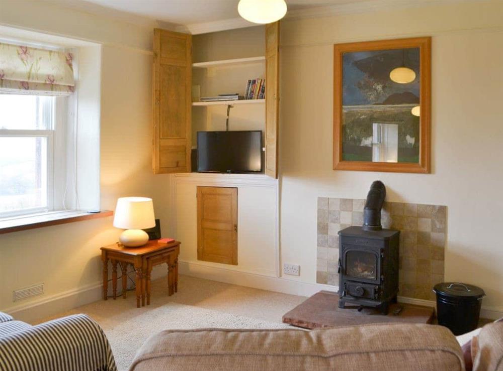 Tastefully furnished living/dining room with wood burner (photo 3) at Loadpot in Ullswater, Cumbria