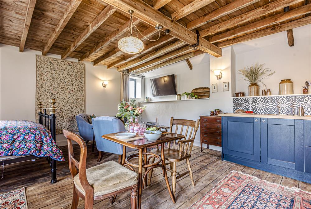 The open-plan sleeping, sitting and dining space with attractive kitchen at Loaf, Bridport