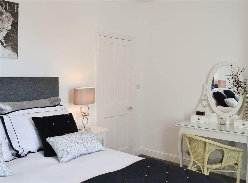 Lovely bedroom with attractive dressing area at Lobster Pot Cottage in Scarborough, North Yorkshire