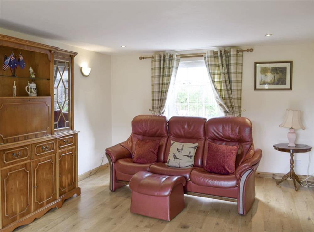 Ample comfy seating within living room at The Ploughmans, 