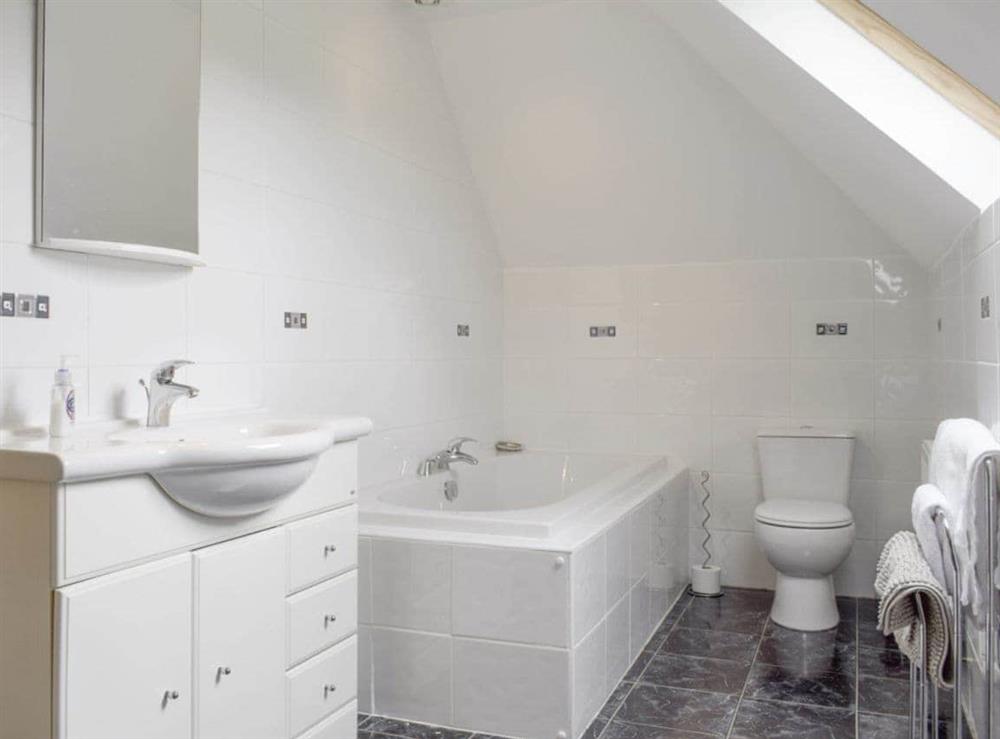 Family bathroom with separate bath and shower cubicle at The Stables, 