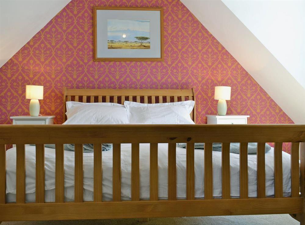 Comfortable double bedroom with kingsize bed at Loch Shore Cottage in Dornie, near Kyle, Ross-Shire