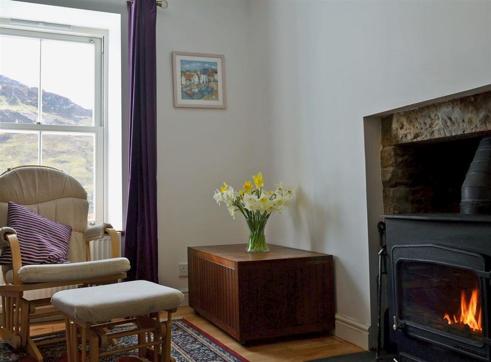 Homely living room with cosy multi-fuel burner (photo 2) at Loch Shore Cottage in Dornie, near Kyle, Ross-Shire
