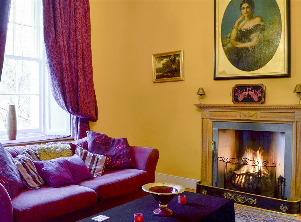 Open fire in the characterful living room at Lochside Garden House in Kelso, Roxburghshire