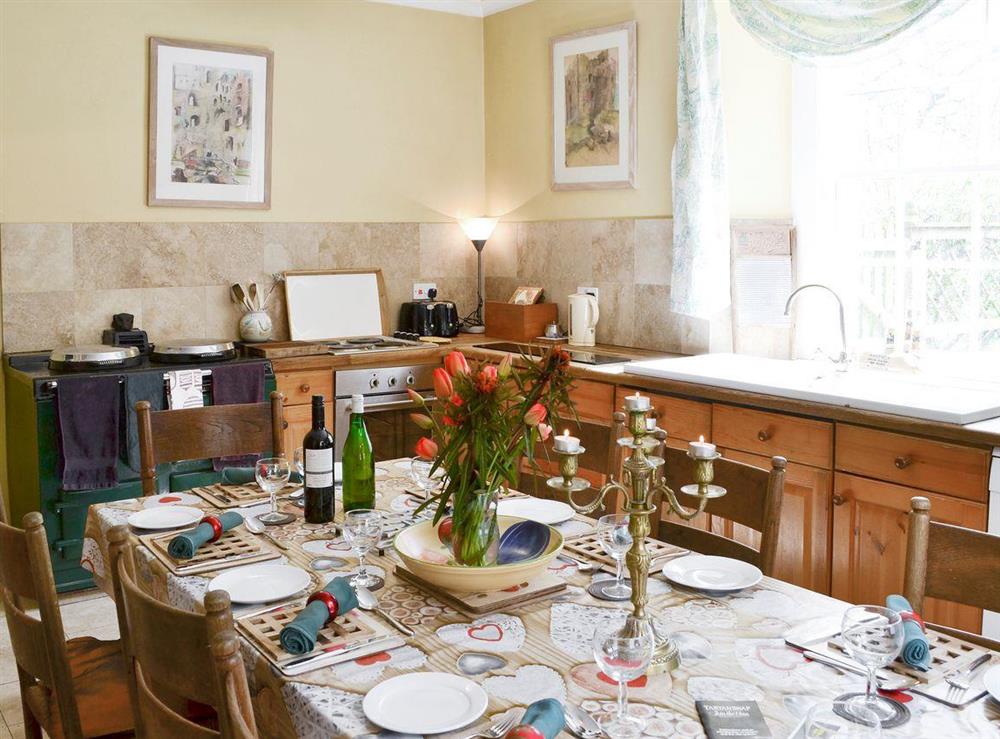 Well-equipped kitchen with dining area at Lochside Garden House in Kelso, Roxburghshire