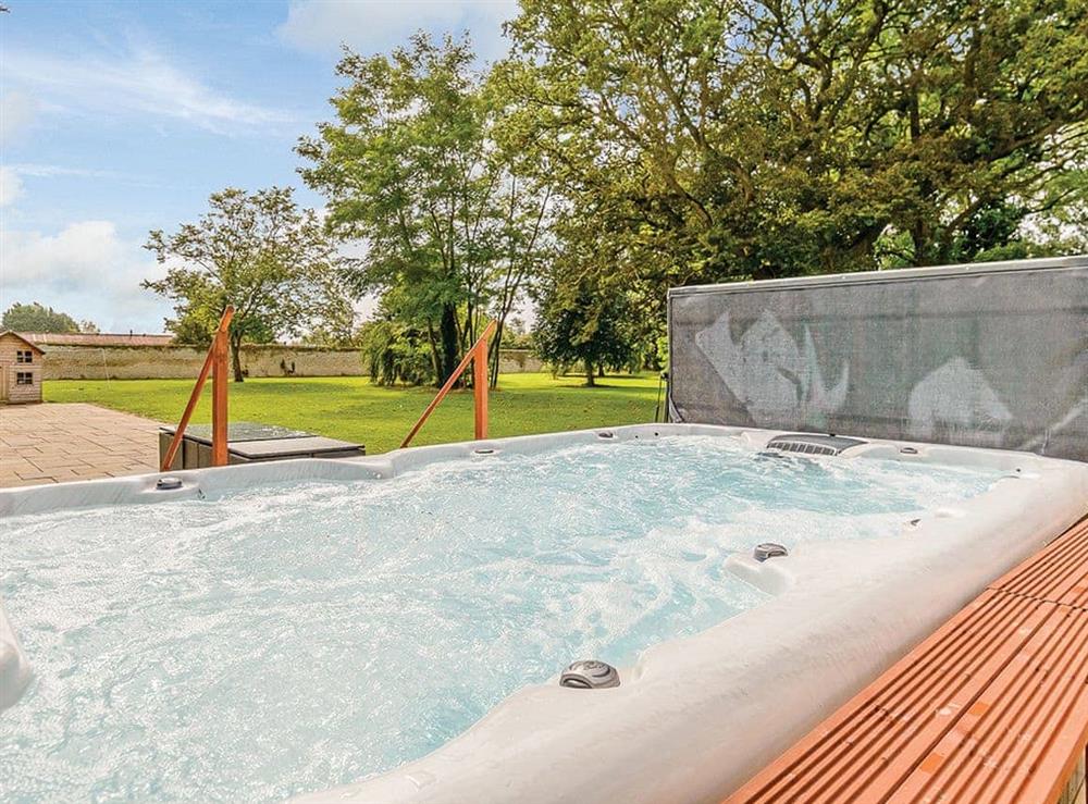 Luxurious hot tub on paved patio at Lode Hall in Three Holes, near Downham Market, Norfolk