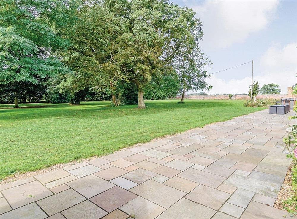 Paved patio and garden at Lode Hall in Three Holes, near Downham Market, Norfolk