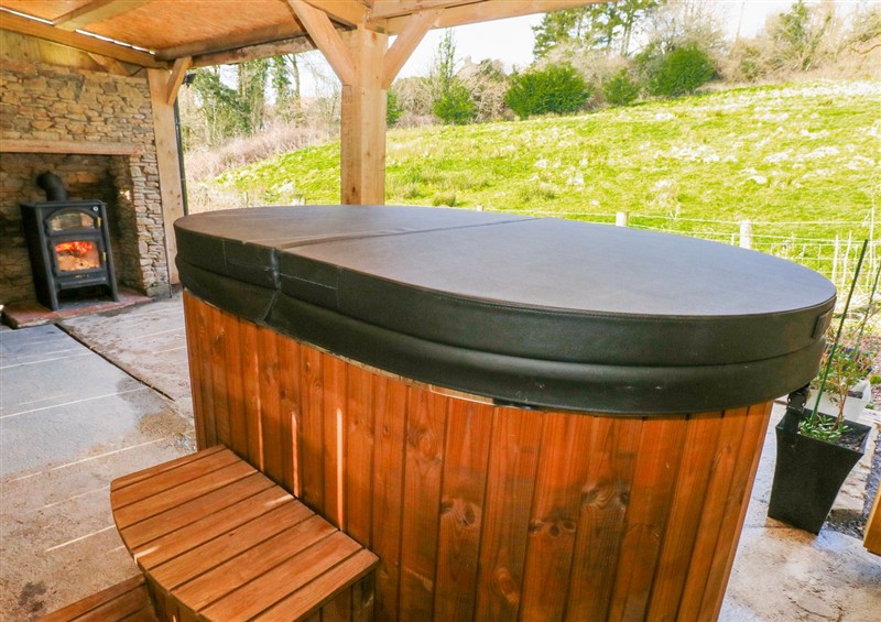 Relax in the hot tub at Lodge 1, near Pontyates