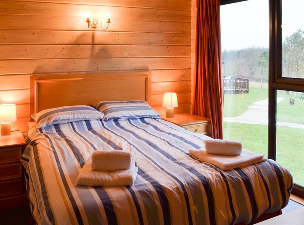 Cosy and romantic double bedroom with great views at Lodge 59 in Hartland Forest, near Bideford, Devon