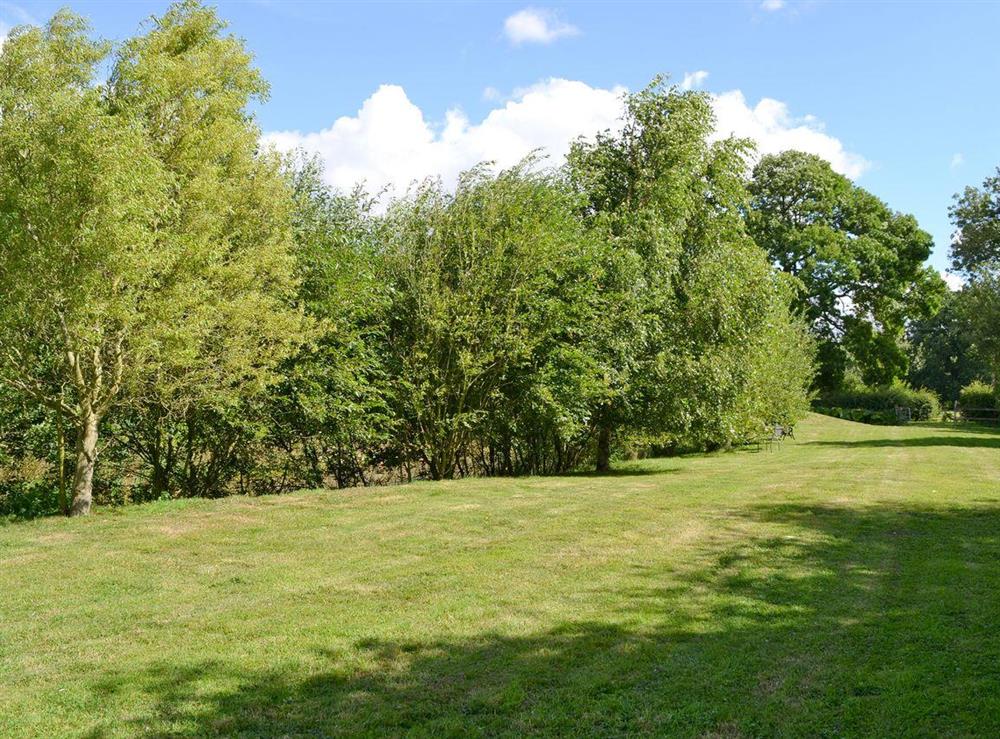 Shared lawned garden area at Lodge Cottage in Scarning, near Dereham, Norfolk