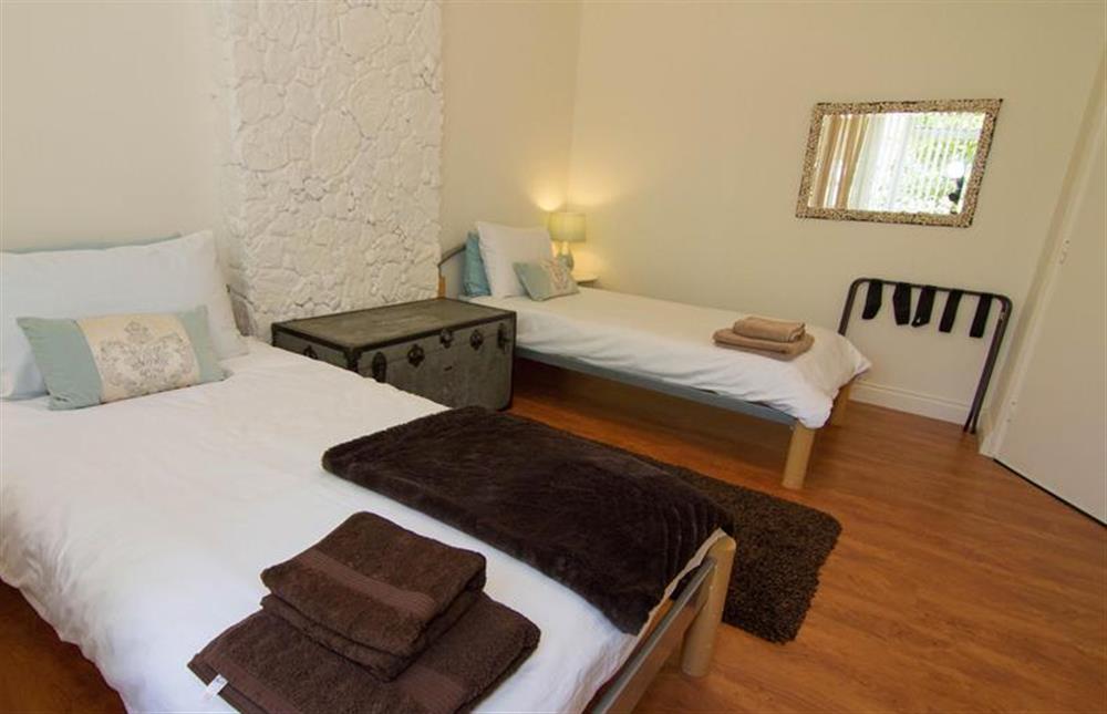 Bedroom two:  With full-size twin beds and room for a cot at Lodge End, Heacham near Kings Lynn