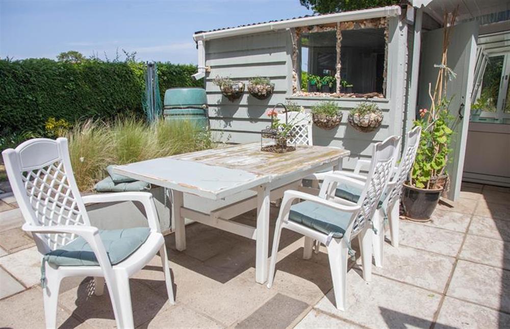Enclosed garden:  With patio area with table and seating for four at Lodge End, Heacham near Kings Lynn
