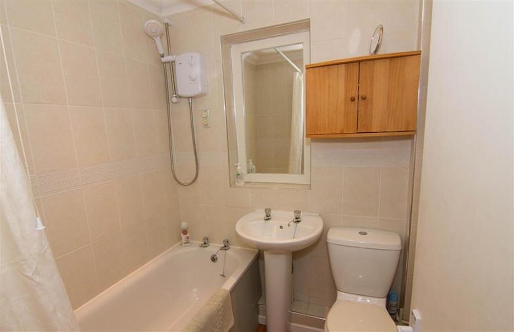 Ground floor:  Bathroom with bath with shower over at Lodge End, Heacham near Kings Lynn