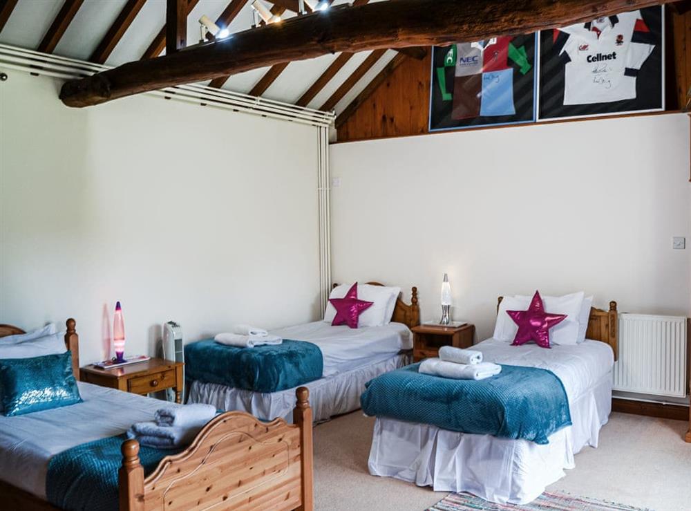 This large bedroom is great for the children has plenty of floor space.  French doors to courtyard at Lodge Farm Barn in South Walsham, North Norfolk, England