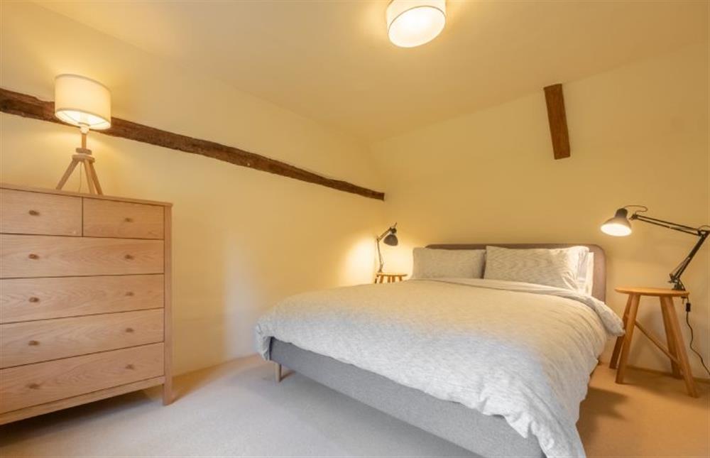 First floor: Master bedroom with a king-size bed at Loke Cottage, Bessingham near Norwich