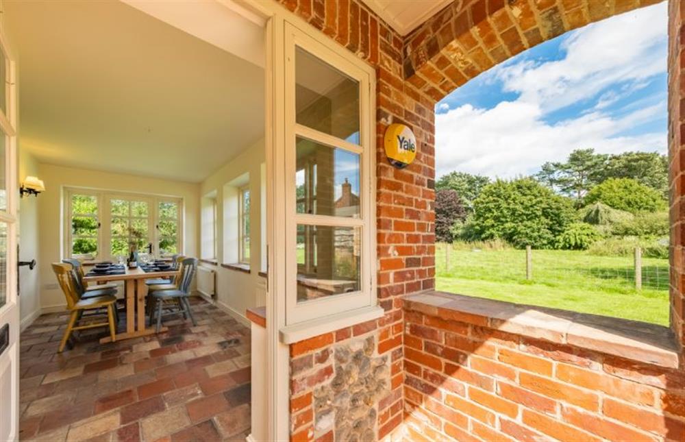 Ground floor: Enter into dining room with seating for six guests and large windows with lovely views over the garden