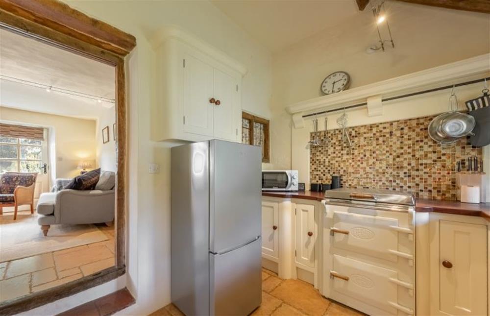 Ground floor: Kitchen with view to sitting room at Loke Cottage, Bessingham near Norwich