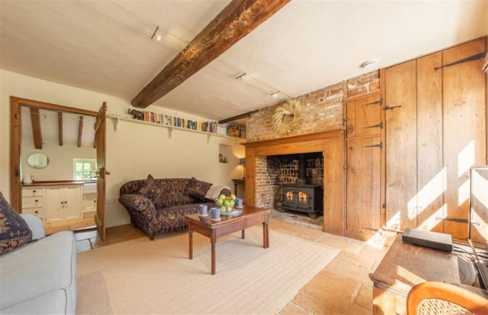 Ground floor: Sitting room with wood burning stove and Smart television at Loke Cottage, Bessingham near Norwich